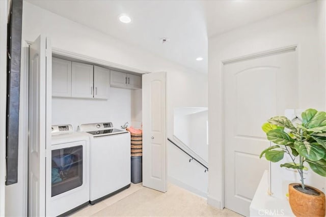 washroom featuring separate washer and dryer and light colored carpet