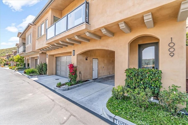 doorway to property with a garage