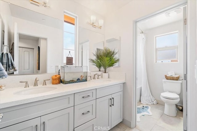 bathroom with tile patterned floors, vanity, and toilet