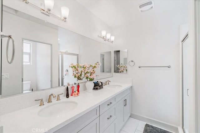 bathroom featuring vanity, toilet, and walk in shower