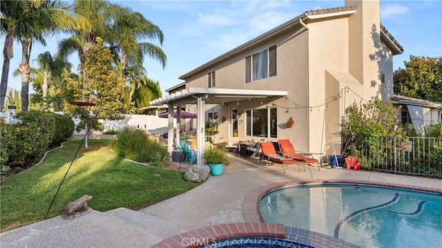 back of house featuring a fenced in pool, a yard, stucco siding, a patio area, and fence