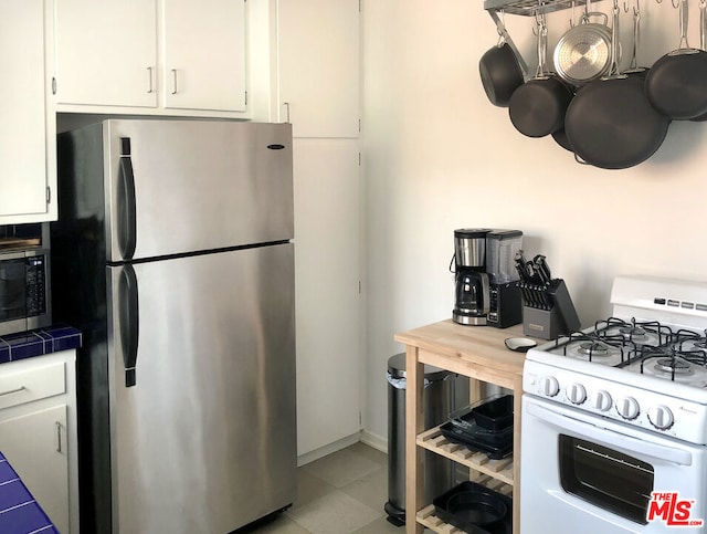 kitchen with white cabinets and appliances with stainless steel finishes