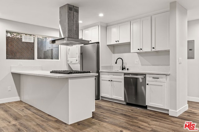 kitchen featuring island exhaust hood, white cabinetry, hardwood / wood-style floors, and appliances with stainless steel finishes