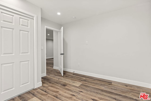 unfurnished bedroom featuring hardwood / wood-style flooring