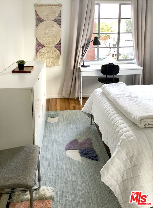 bedroom with wood-type flooring