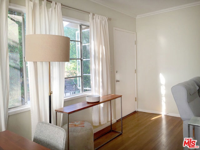 dining area with ornamental molding and hardwood / wood-style flooring