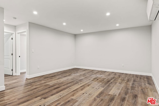 unfurnished room with wood-type flooring