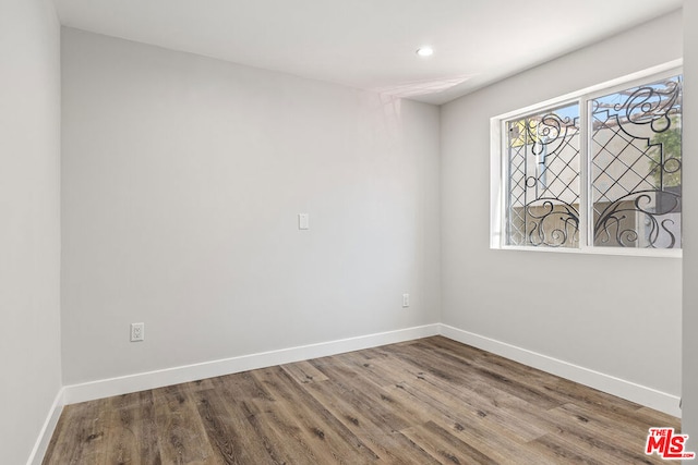 empty room with hardwood / wood-style flooring