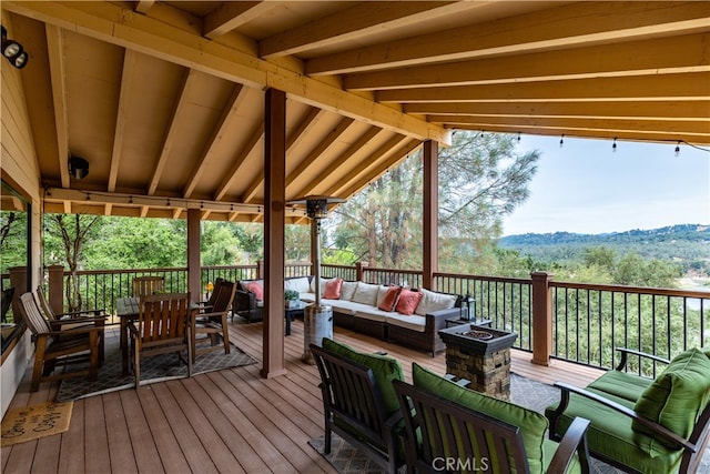 wooden terrace featuring outdoor lounge area