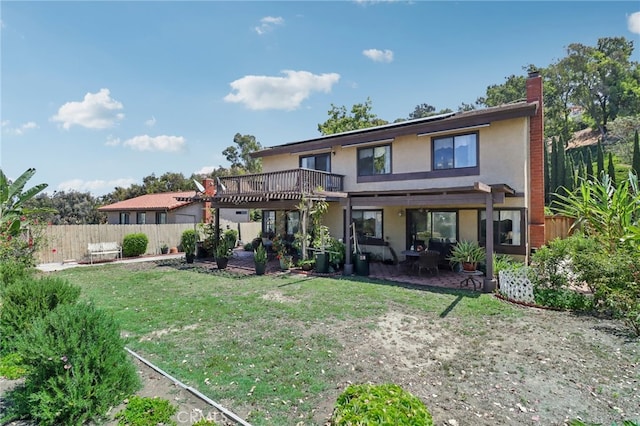 rear view of house with a lawn and a patio area