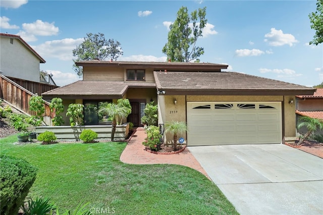 view of front of house featuring a garage and a front lawn