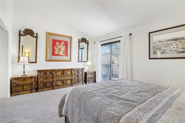 bedroom with access to outside, vaulted ceiling, and carpet