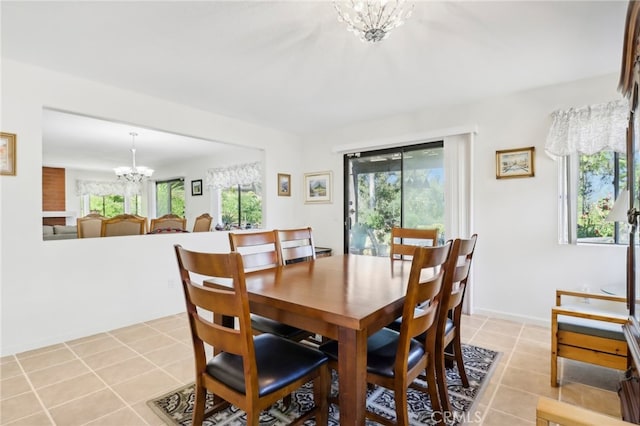 tiled dining area with an inviting chandelier and a wealth of natural light