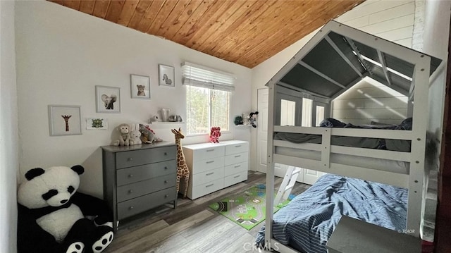 bedroom featuring lofted ceiling, wood ceiling, and light hardwood / wood-style flooring