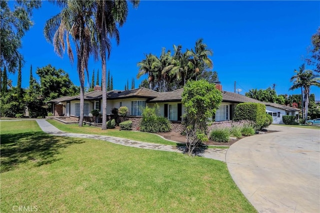 ranch-style home with a front lawn