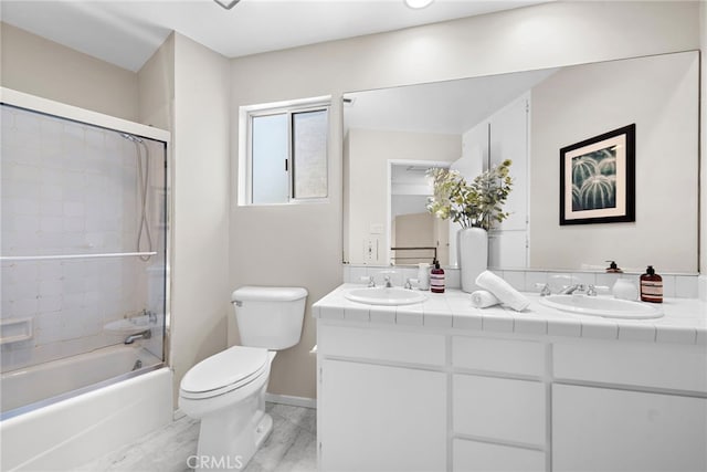 full bathroom with toilet, tiled shower / bath combo, hardwood / wood-style flooring, and vanity