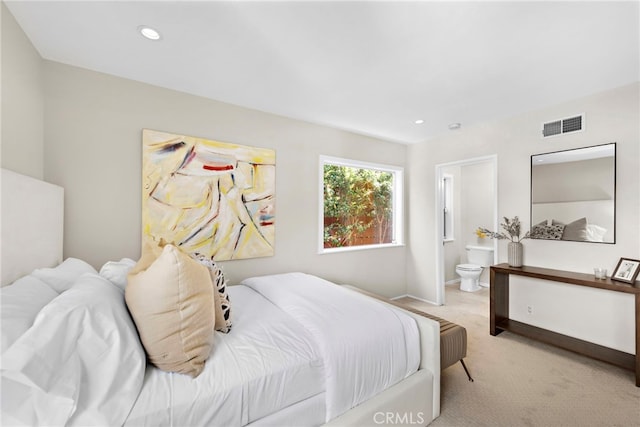 carpeted bedroom with ensuite bathroom