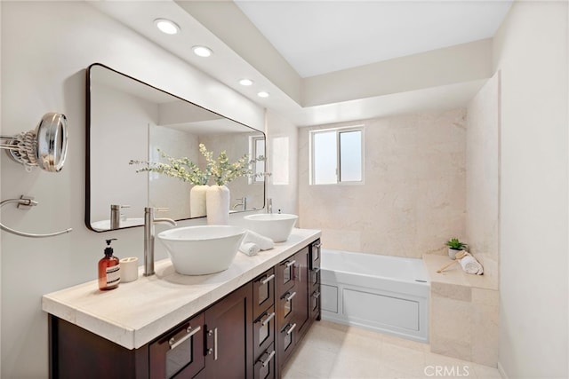 bathroom with vanity, a bathtub, and tile patterned flooring