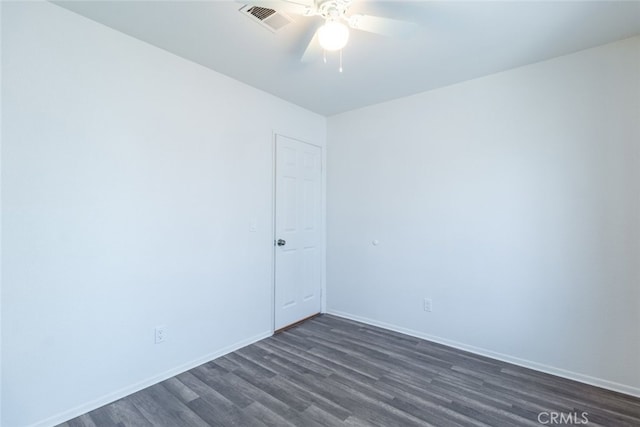 spare room with ceiling fan and dark hardwood / wood-style flooring