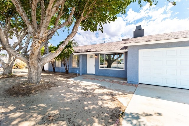 ranch-style house featuring a garage