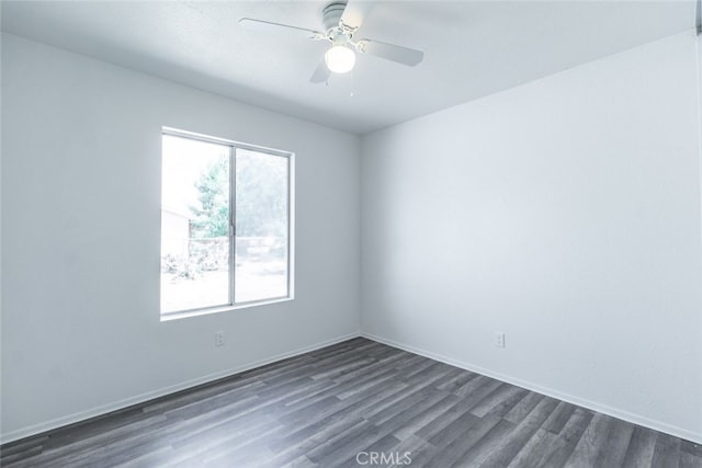 unfurnished room featuring ceiling fan and dark hardwood / wood-style flooring