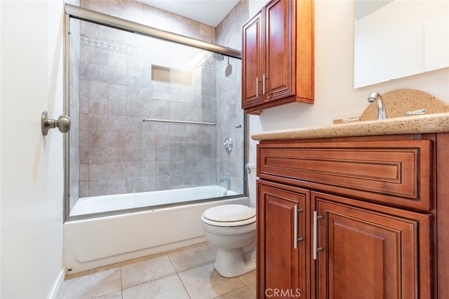 full bathroom with tile patterned flooring, enclosed tub / shower combo, vanity, and toilet