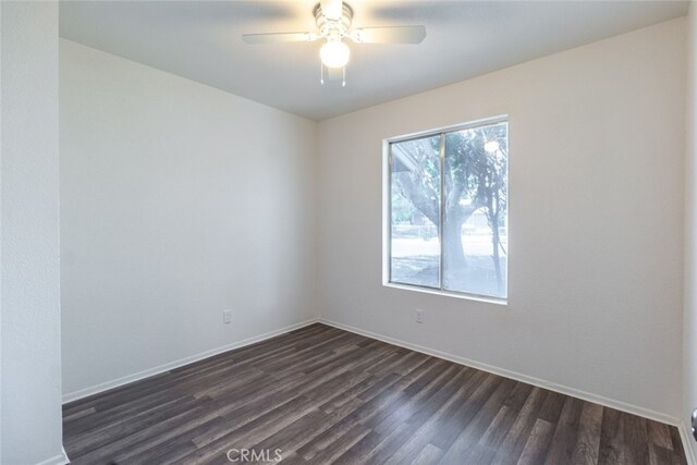 empty room featuring dark hardwood / wood-style floors and ceiling fan