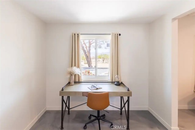 home office featuring concrete flooring