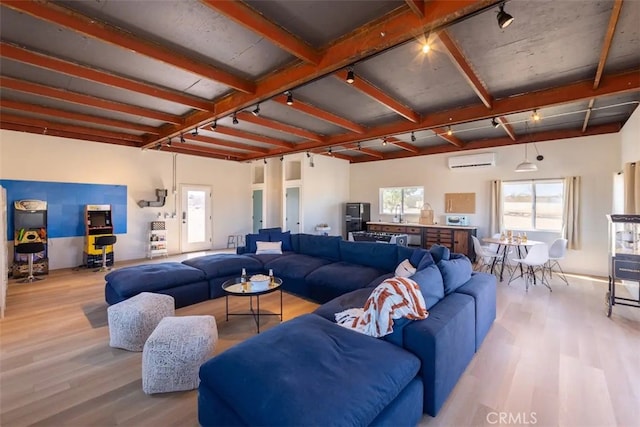 living room featuring an AC wall unit and light wood-type flooring