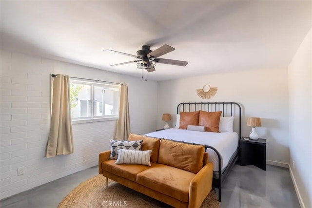 bedroom featuring concrete flooring, brick wall, and ceiling fan