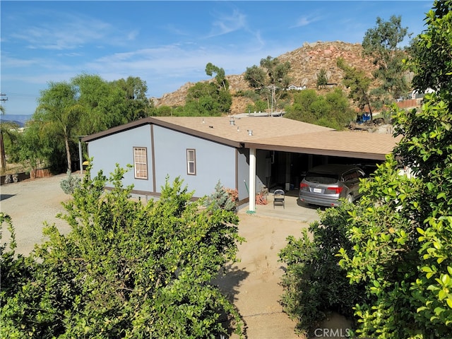 ranch-style house featuring a mountain view and a carport