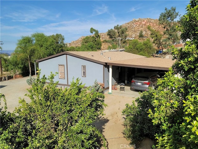 ranch-style house featuring a mountain view and a carport