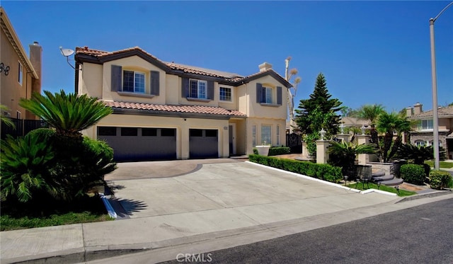 mediterranean / spanish home with a garage