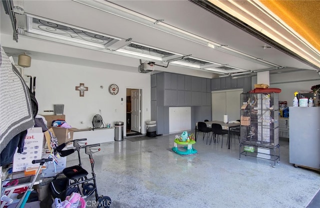 garage with white refrigerator and a garage door opener