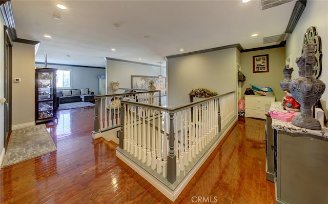 hall with ornamental molding and hardwood / wood-style flooring