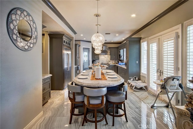 interior space with a chandelier and ornamental molding