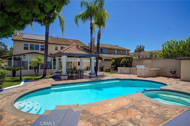 view of pool with a patio, a gazebo, and an in ground hot tub