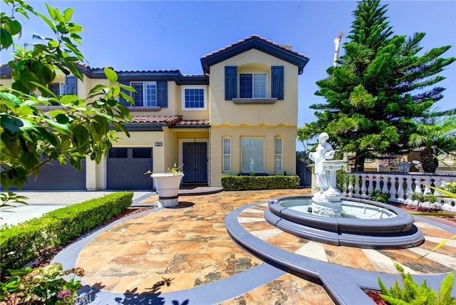 mediterranean / spanish-style house with a garage