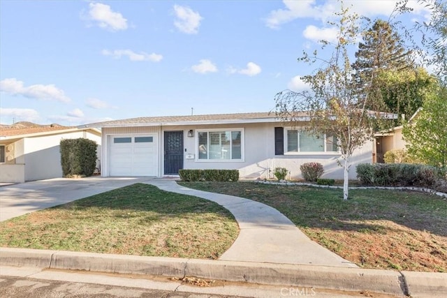 single story home featuring a garage and a front lawn