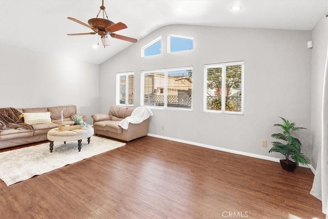 living room with ceiling fan, dark wood-type flooring, and vaulted ceiling