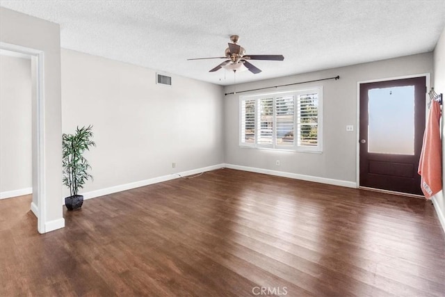 interior space with dark hardwood / wood-style floors, ceiling fan, and a textured ceiling