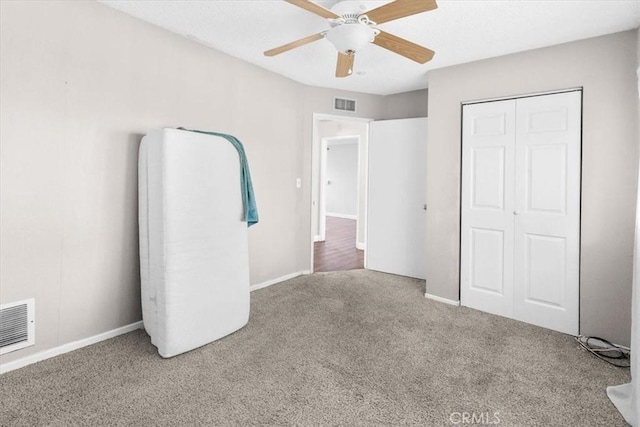 unfurnished bedroom featuring carpet, a closet, and ceiling fan