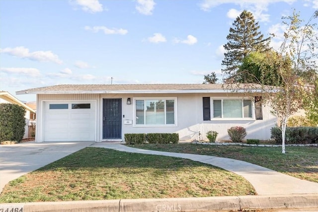 ranch-style home with a garage and a front lawn