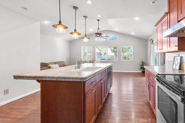 kitchen featuring lofted ceiling, a kitchen island with sink, a healthy amount of sunlight, and sink