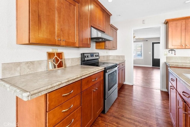 kitchen with electric stove, ceiling fan, dark hardwood / wood-style flooring, and exhaust hood