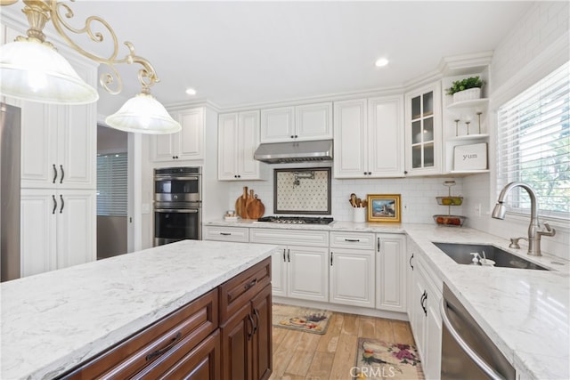 kitchen featuring white cabinets, appliances with stainless steel finishes, and sink