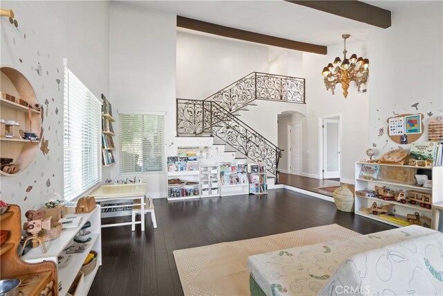 kitchen featuring a notable chandelier, a high ceiling, beamed ceiling, and dark hardwood / wood-style floors