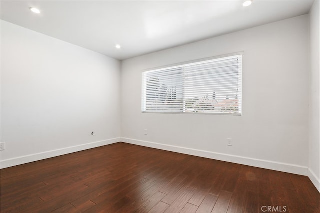 spare room with dark hardwood / wood-style floors