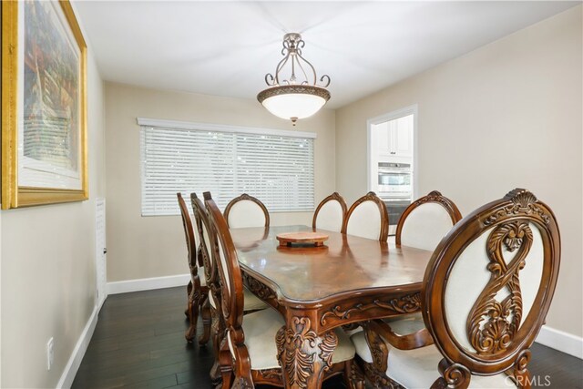 dining space with dark hardwood / wood-style flooring