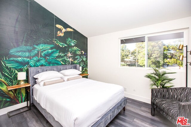 bedroom featuring hardwood / wood-style floors and lofted ceiling